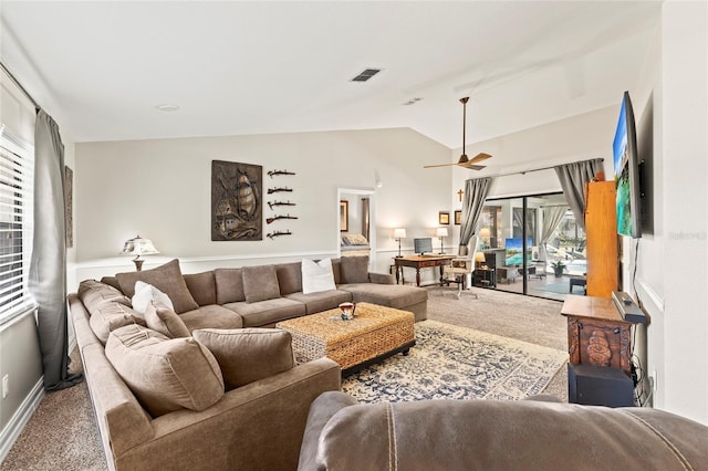 living room featuring lofted ceiling, ceiling fan, and carpet