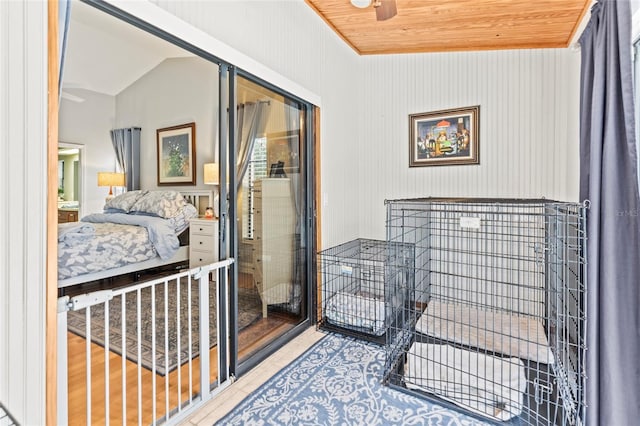 tiled bedroom featuring vaulted ceiling and wooden ceiling