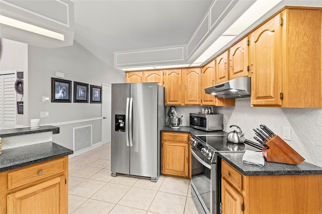 kitchen with light tile patterned floors, backsplash, and stainless steel appliances