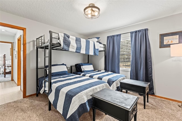 bedroom with light carpet and a textured ceiling