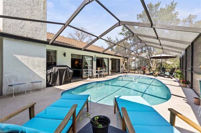 view of pool featuring a patio area and glass enclosure