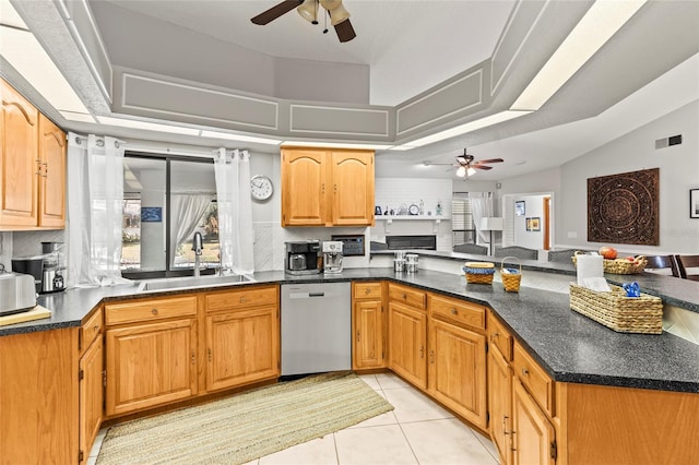 kitchen featuring sink, light tile patterned floors, dishwasher, decorative backsplash, and kitchen peninsula