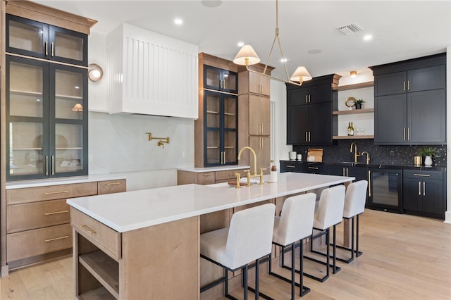 kitchen with open shelves, wine cooler, light wood-style flooring, and visible vents