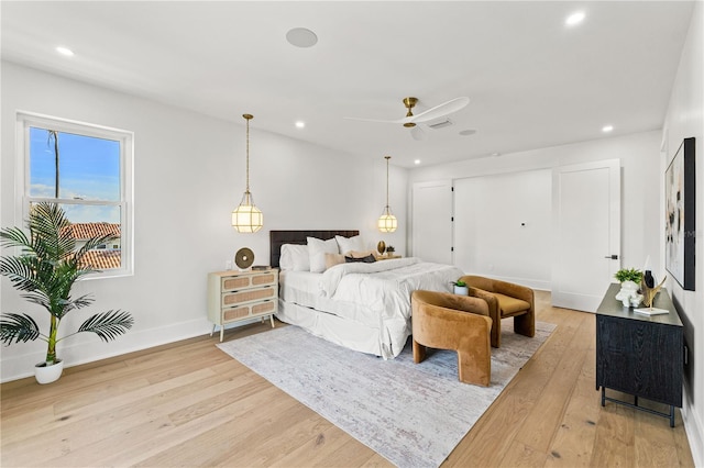 bedroom with baseboards, light wood-type flooring, and recessed lighting