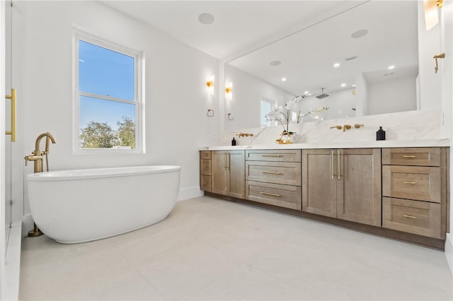 bathroom with tile patterned flooring, a soaking tub, and double vanity