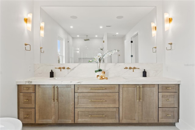 bathroom with a sink, backsplash, and double vanity