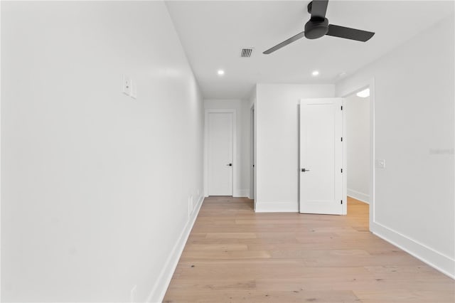 interior space with light wood finished floors, baseboards, visible vents, and recessed lighting