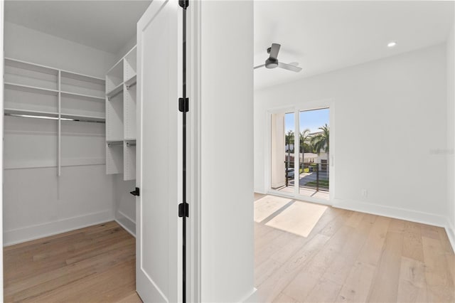 spacious closet featuring wood finished floors and a ceiling fan