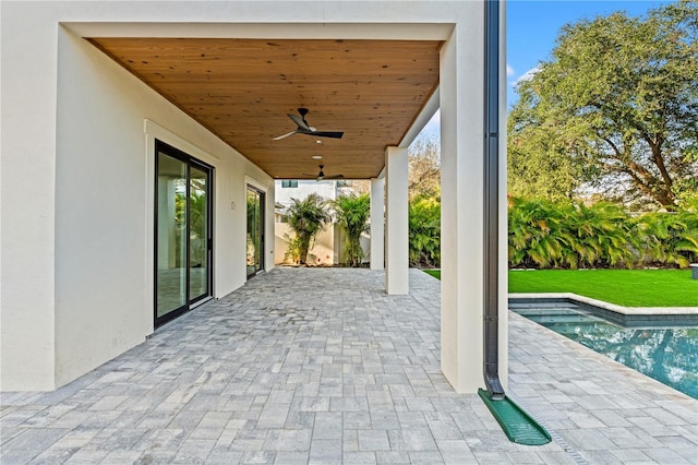 view of patio / terrace featuring a ceiling fan and an outdoor pool