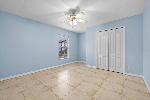 unfurnished bedroom with a textured ceiling, a closet, and ceiling fan