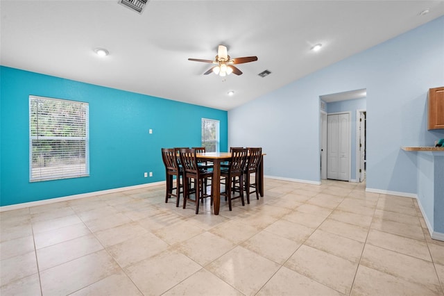 tiled dining area with vaulted ceiling and ceiling fan