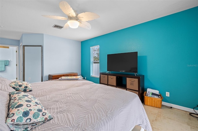 tiled bedroom featuring ceiling fan