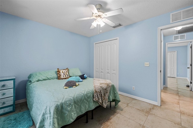 bedroom featuring light tile patterned floors, a closet, and ceiling fan