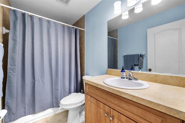 bathroom featuring tile patterned flooring, vanity, and toilet