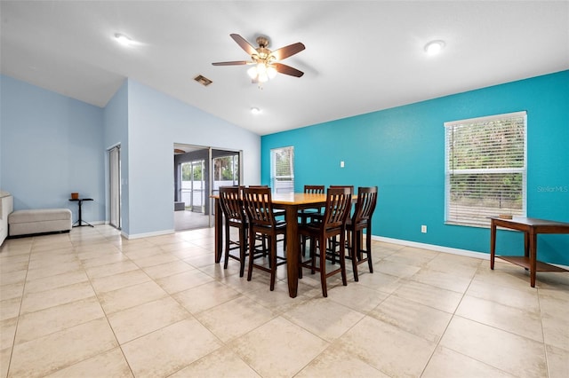 tiled dining area featuring lofted ceiling and ceiling fan