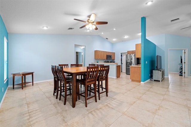 dining area featuring lofted ceiling and ceiling fan