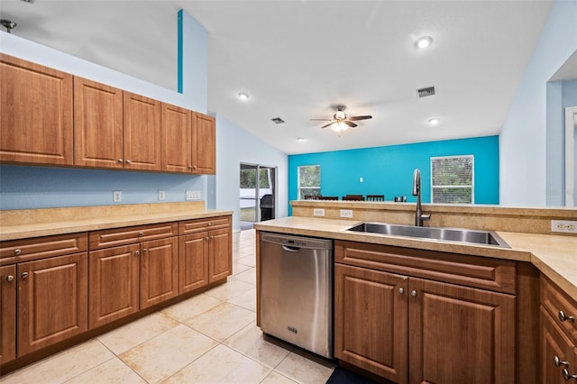 kitchen with lofted ceiling, sink, light tile patterned floors, dishwasher, and ceiling fan