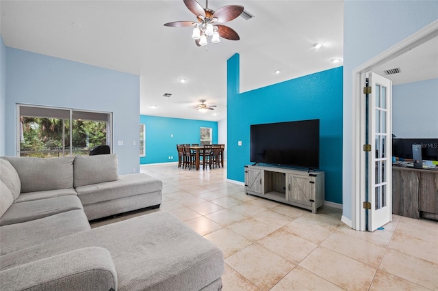 living room featuring light tile patterned floors and ceiling fan