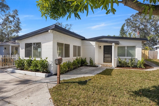 ranch-style home featuring a front lawn