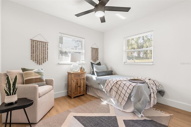 bedroom with ceiling fan and light hardwood / wood-style flooring