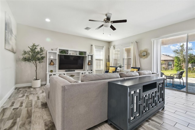 living room with hardwood / wood-style flooring and ceiling fan