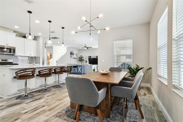 dining area featuring ceiling fan, a healthy amount of sunlight, and light hardwood / wood-style floors