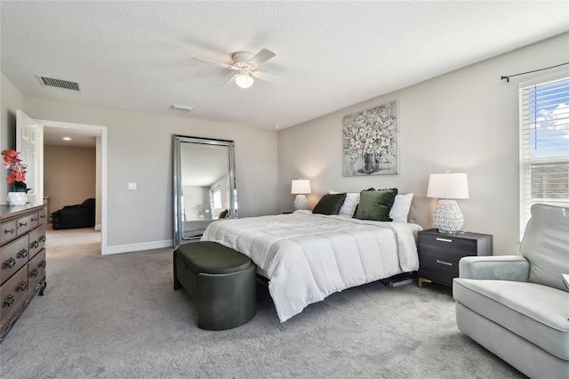 bedroom with carpet flooring, a textured ceiling, and ceiling fan