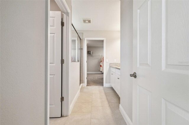 hallway with light tile patterned floors