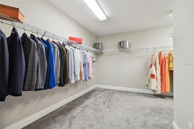 spacious closet with vaulted ceiling and carpet