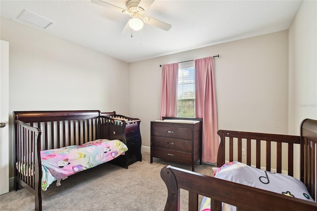 bedroom featuring light colored carpet and ceiling fan