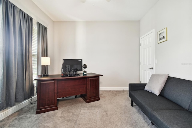 carpeted office featuring ceiling fan