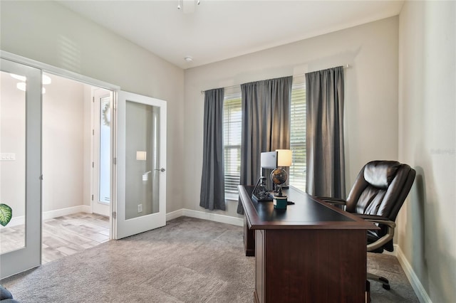 carpeted home office with french doors