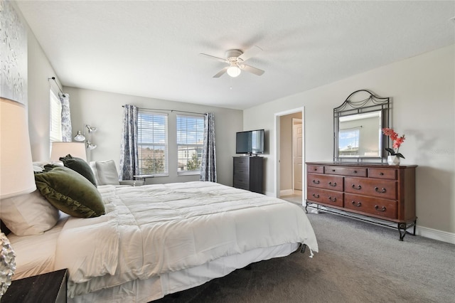 carpeted bedroom with a textured ceiling and ceiling fan