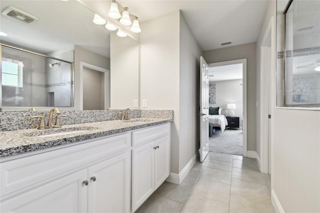 bathroom with vanity, an enclosed shower, and tile patterned floors