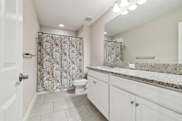 bathroom with tile patterned flooring, vanity, and toilet