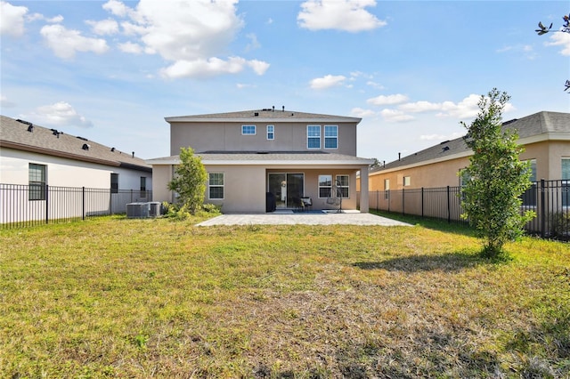 back of house featuring a yard, cooling unit, and a patio area