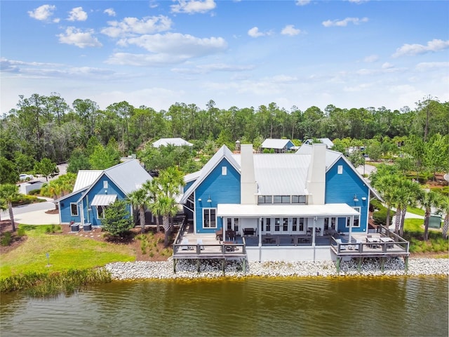 rear view of house featuring a deck with water view