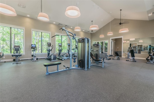 exercise room with high vaulted ceiling