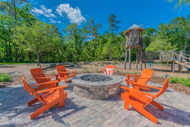 view of patio with a fire pit and a playground