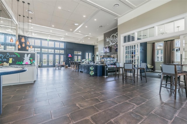 interior space with french doors and a towering ceiling