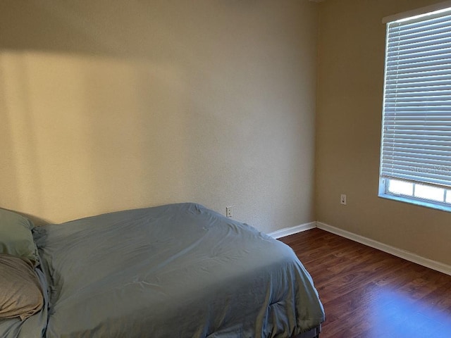 unfurnished bedroom featuring dark hardwood / wood-style floors