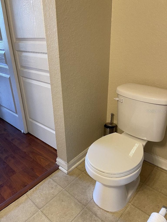 bathroom featuring tile patterned floors and toilet