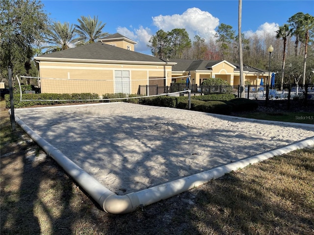 view of side of property featuring volleyball court