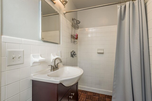 bathroom with vanity, tile walls, parquet floors, and walk in shower