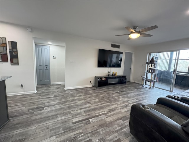 living room with hardwood / wood-style floors and ceiling fan