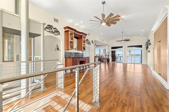 hallway with lofted ceiling and light hardwood / wood-style flooring