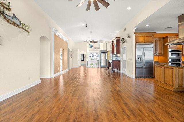 unfurnished living room featuring lofted ceiling, hardwood / wood-style floors, and ceiling fan