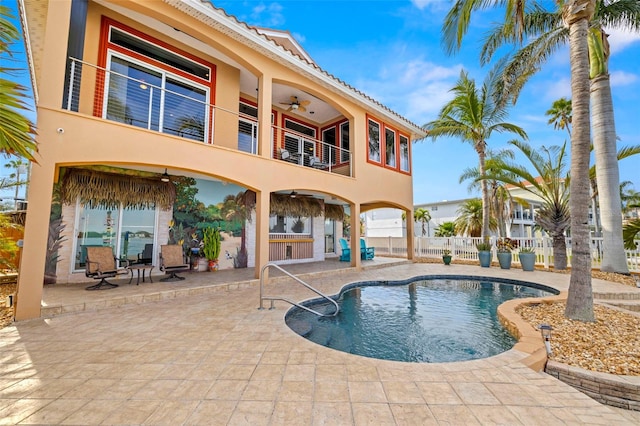 view of pool featuring a bar, a patio, and ceiling fan