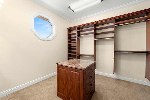 walk in closet featuring light carpet