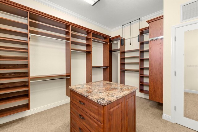 walk in closet featuring light colored carpet